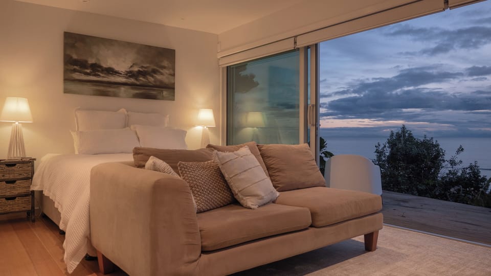 Comfortable couch at the end of the bed