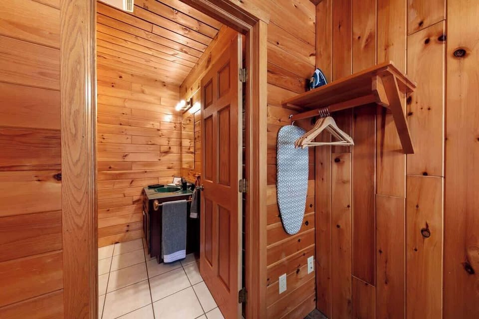 A tabletop and full size ironing board are provided to freshen up clothing. Shelves and hanging space are also available for storage.