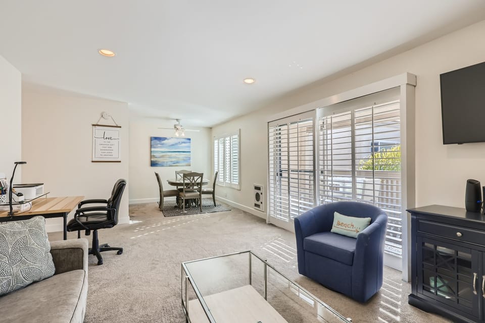 Living room, dining and patio overlooking pool with southern exposure. 700 sq ft