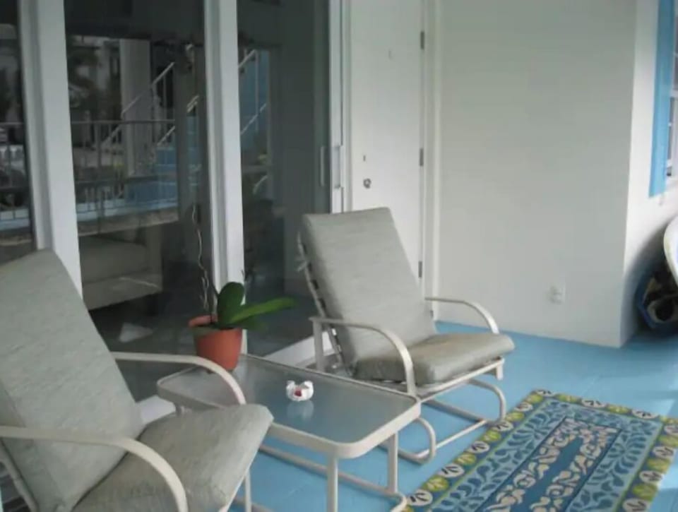 Front patio, screened in area with 2 chairs and table. 