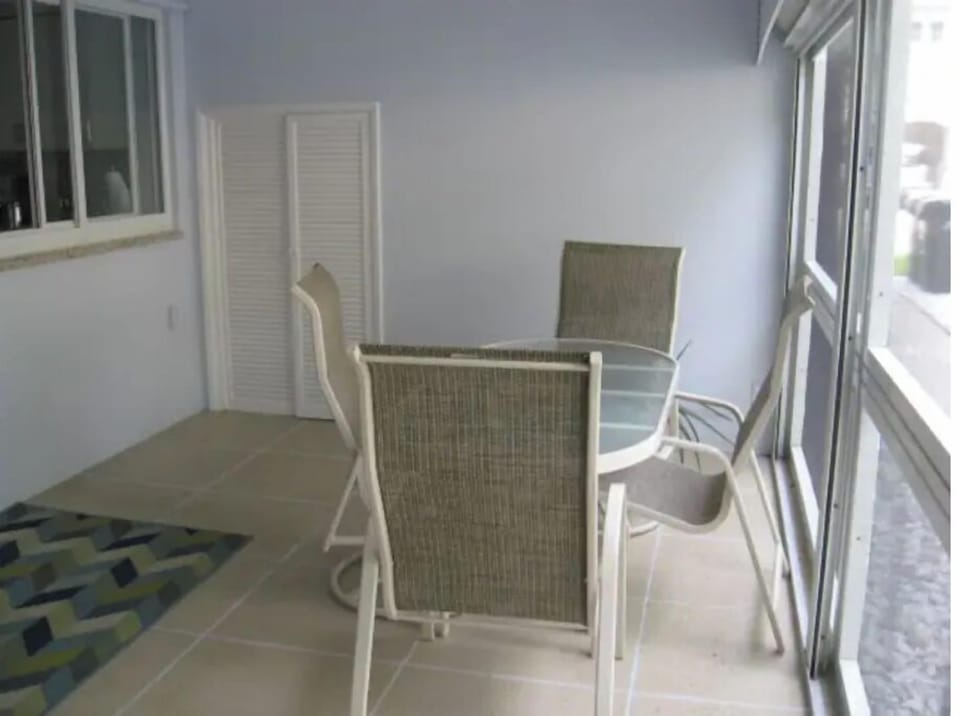 Screened in back patio with table and chairs for 4.