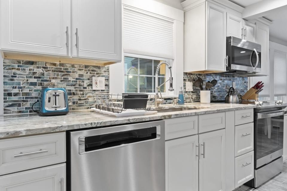 Newly installed kitchen with granite, pull out shelving and dishwasher