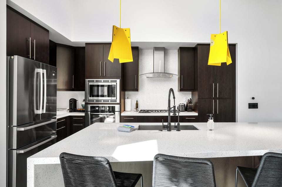 Modern chef's kitchen with quartz island and counter seating