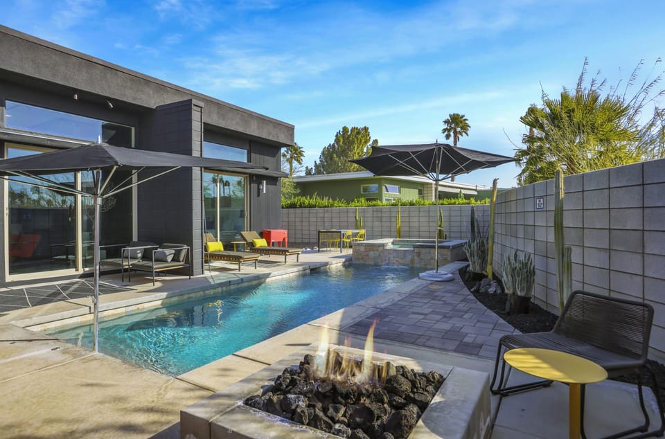 Pool and fire pit framed by the home's striking architecture