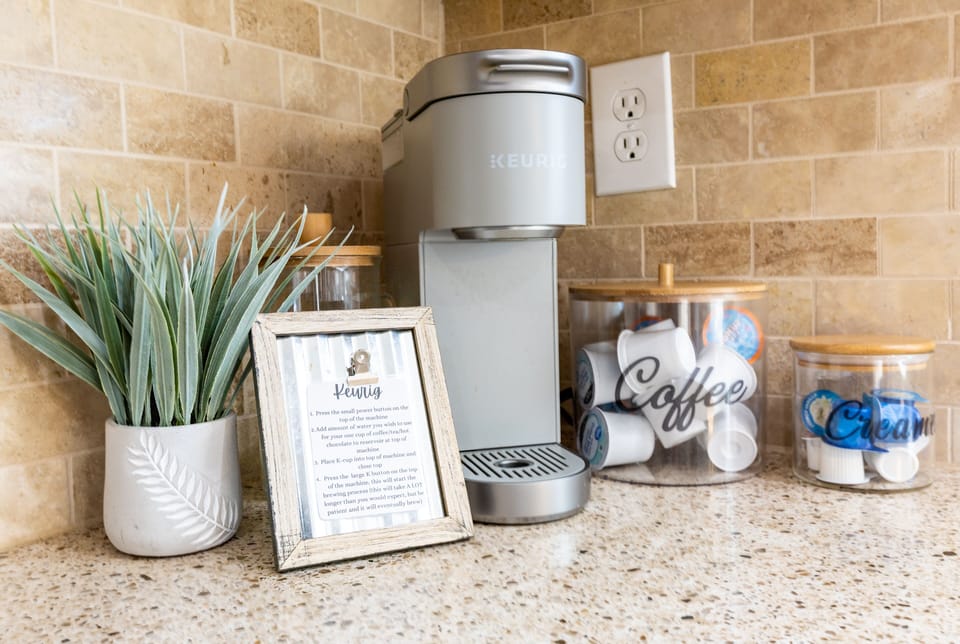 Fully stocked coffee/tea station with Keurig and tea kettle located in kitchen 