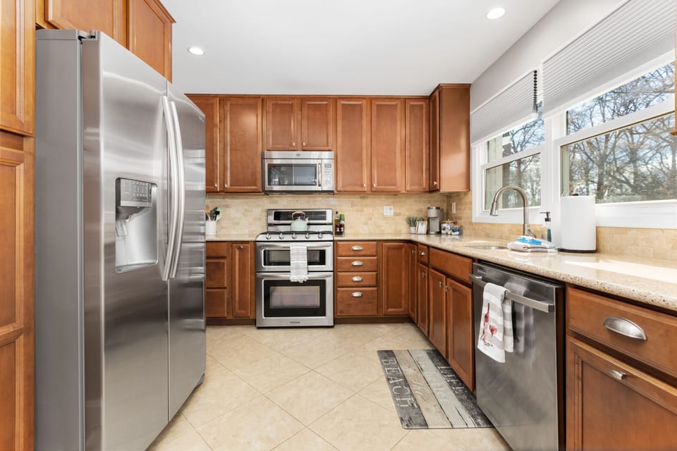 Fully stocked kitchen with stainless steel appliances and gas stove 