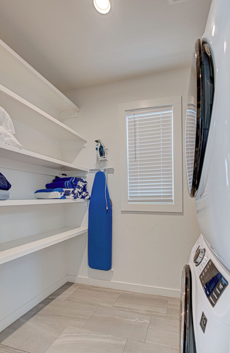 Your dedicated laundry room features built-in shelving, natural light, and modern appliances to keep your vacation wardrobe fresh.