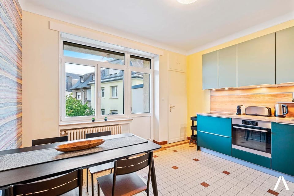 Bright and cozy dining corner with natural light and relaxed seating. Perfect for morning coffee, casual meals, or planning your day in Luxembourg.