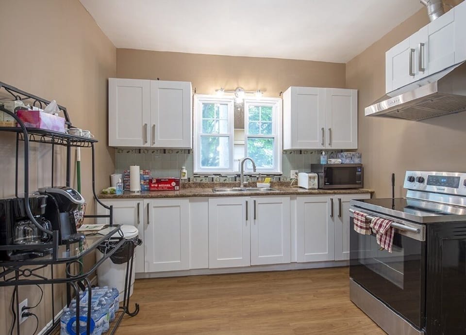 Fully appointed kitchen with fridge, stove, coffee maker, Kurig, & microwave.