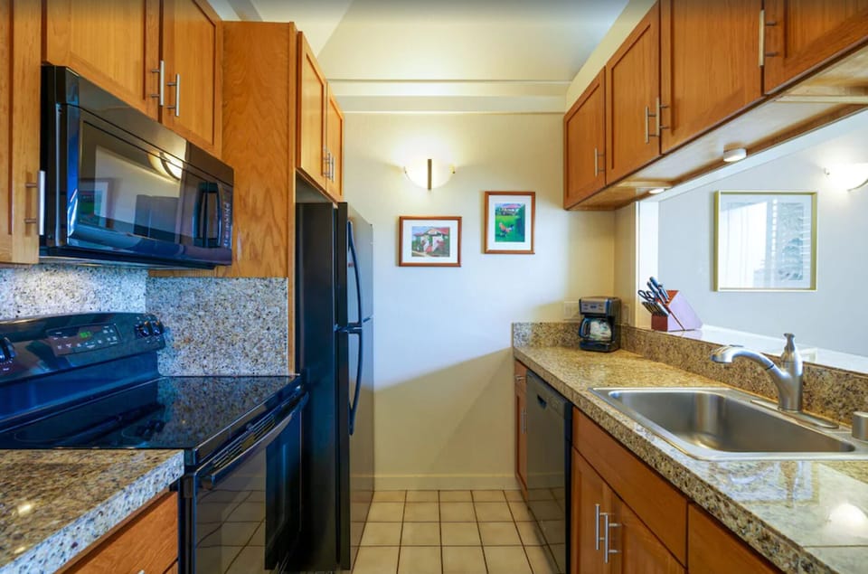Full refrigerator, stove, and microwave for all your cooking needs.