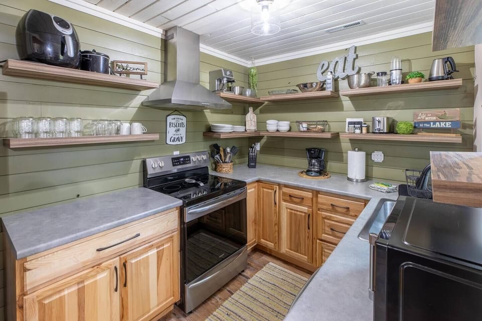 Discover culinary delight in our modern kitchen equipped with sleek appliances, including an oven, coffee maker, kitchenette, and microwave. Elevate your stay with a contemporary cooking experience