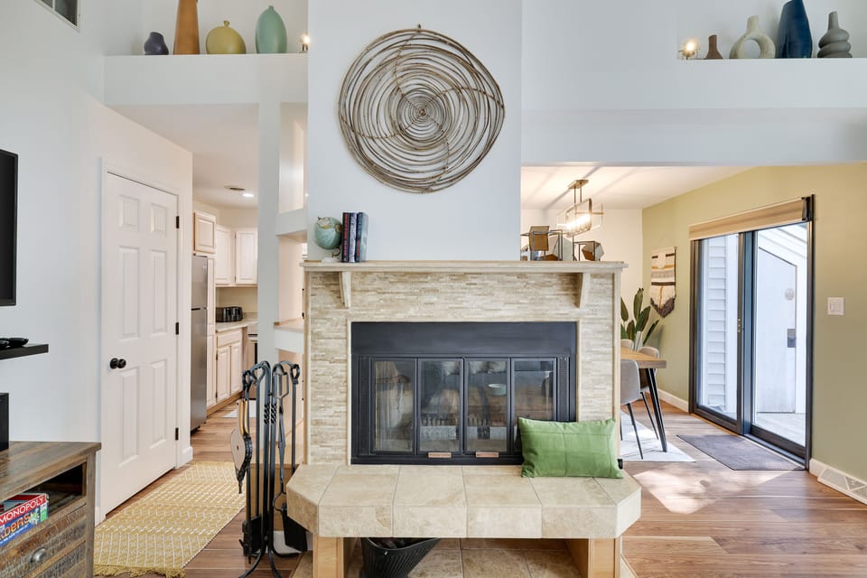 Wood burning fireplace is centrally located between family and kitchen/dining