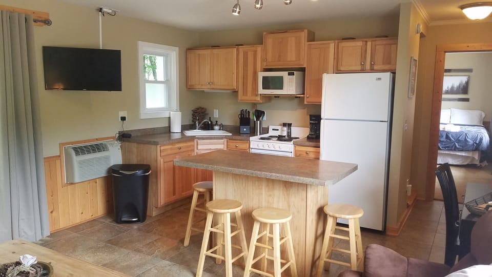 Fully stocked kitchen with island and smart TV