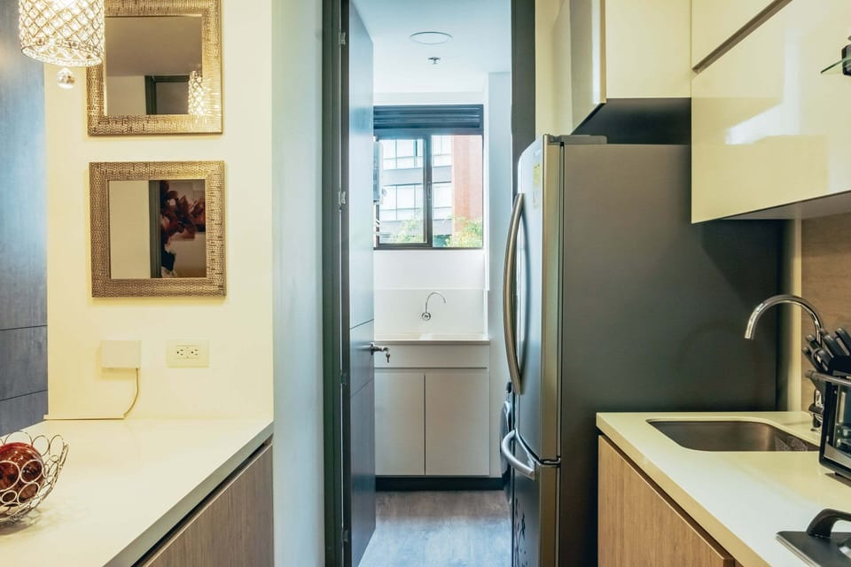 next to the kitchen there is a laundry room with a washing machine