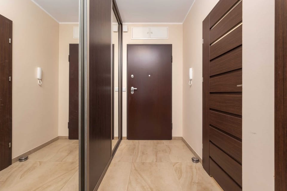 Another hallway view with modern doors leading to spacious rooms.
