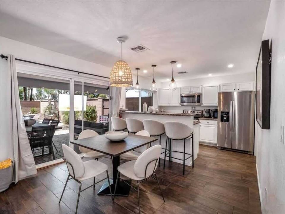 Your open-concept dining and kitchen space flows seamlessly to a sunny patio, perfect for meals that spill outdoors and relaxed gatherings with family or friends.
