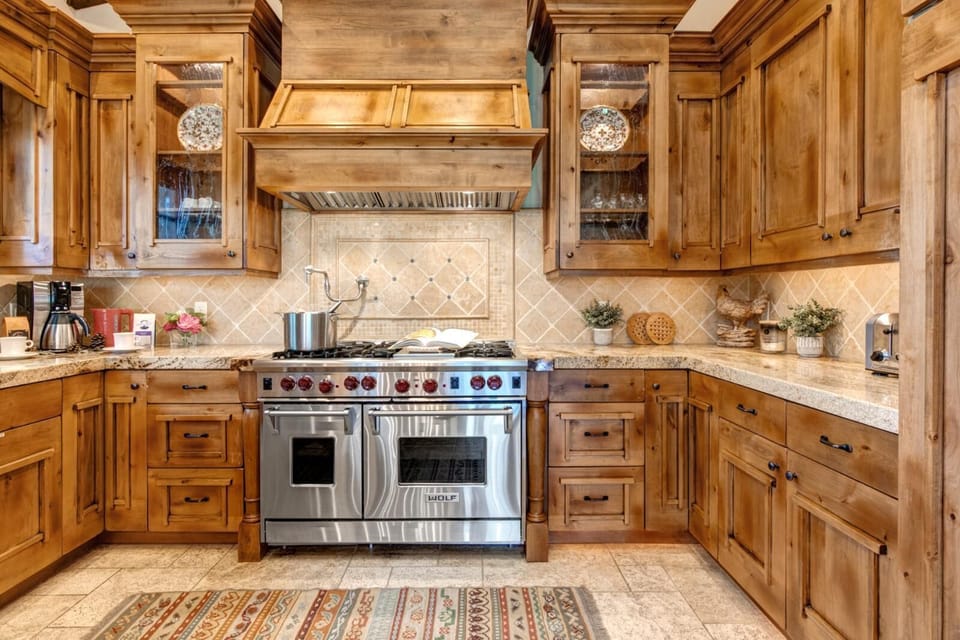 Your chef’s kitchen features high-end appliances, double ovens, and custom wood cabinetry for unforgettable group meals.