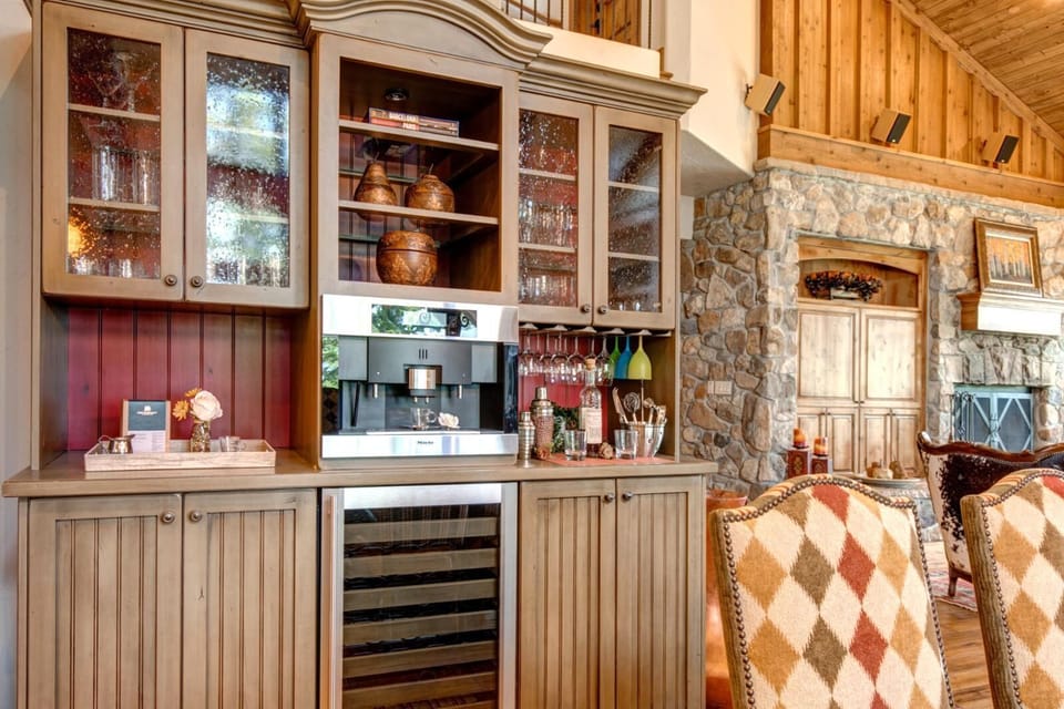     Rustic beverage station blends modern appliances with cozy cabin charm.