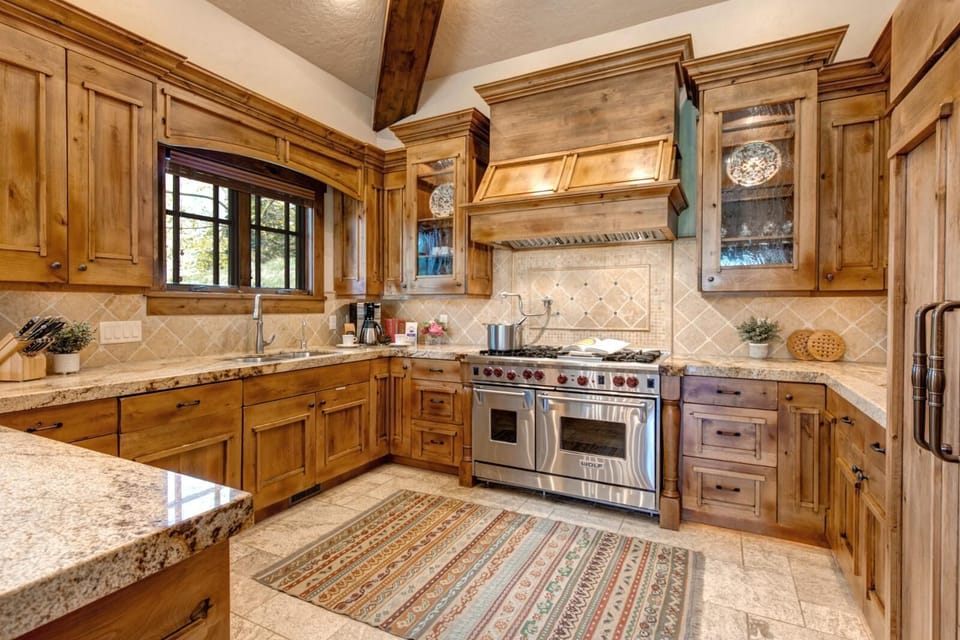 A full view of your kitchen’s custom millwork, professional-grade appliances, and granite counters.