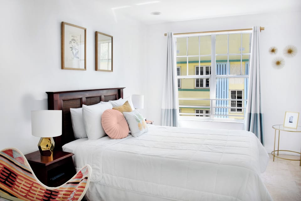 Unwind in crisp linens beside bright windows and sunshine.