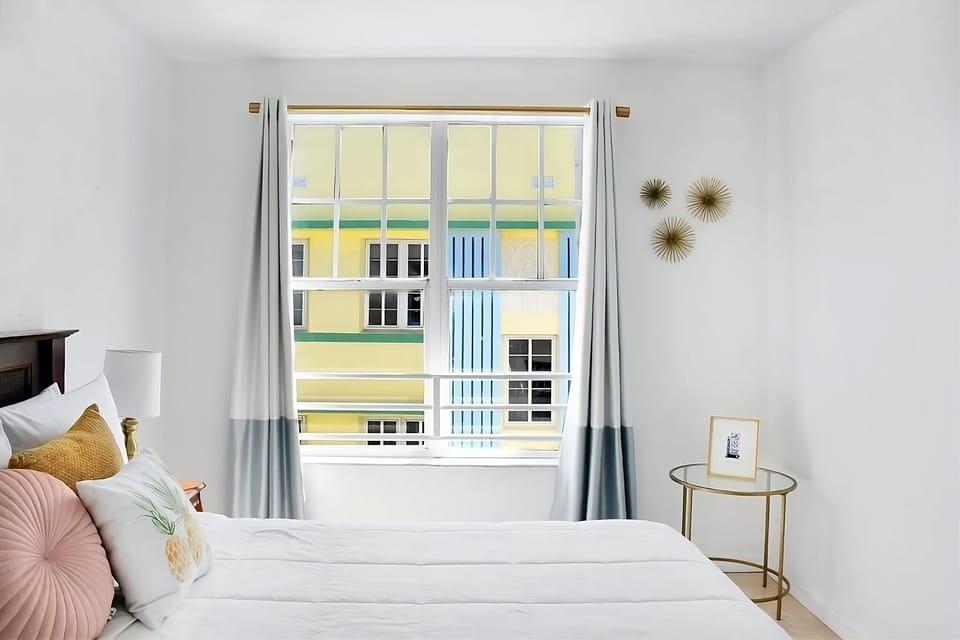 Soak in soft daylight and a clean, minimalist bedroom vibe.
