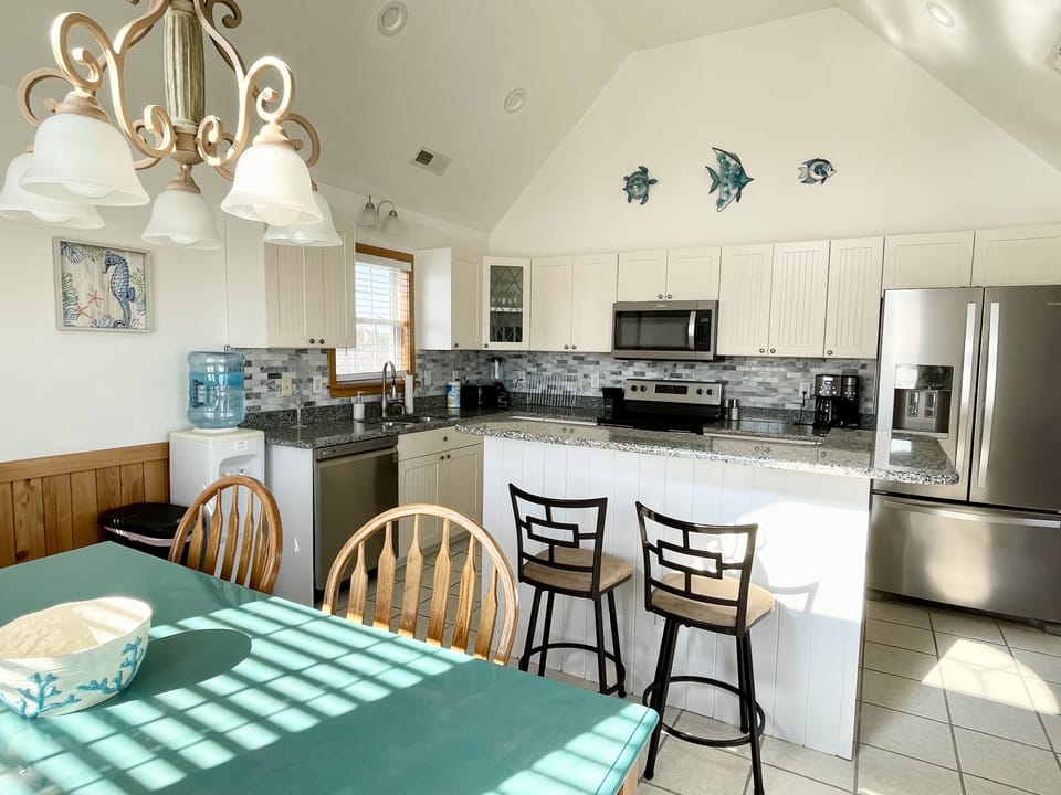 Kitchen has stainless steel dishwasher, microwave, oven and fridge with door ice