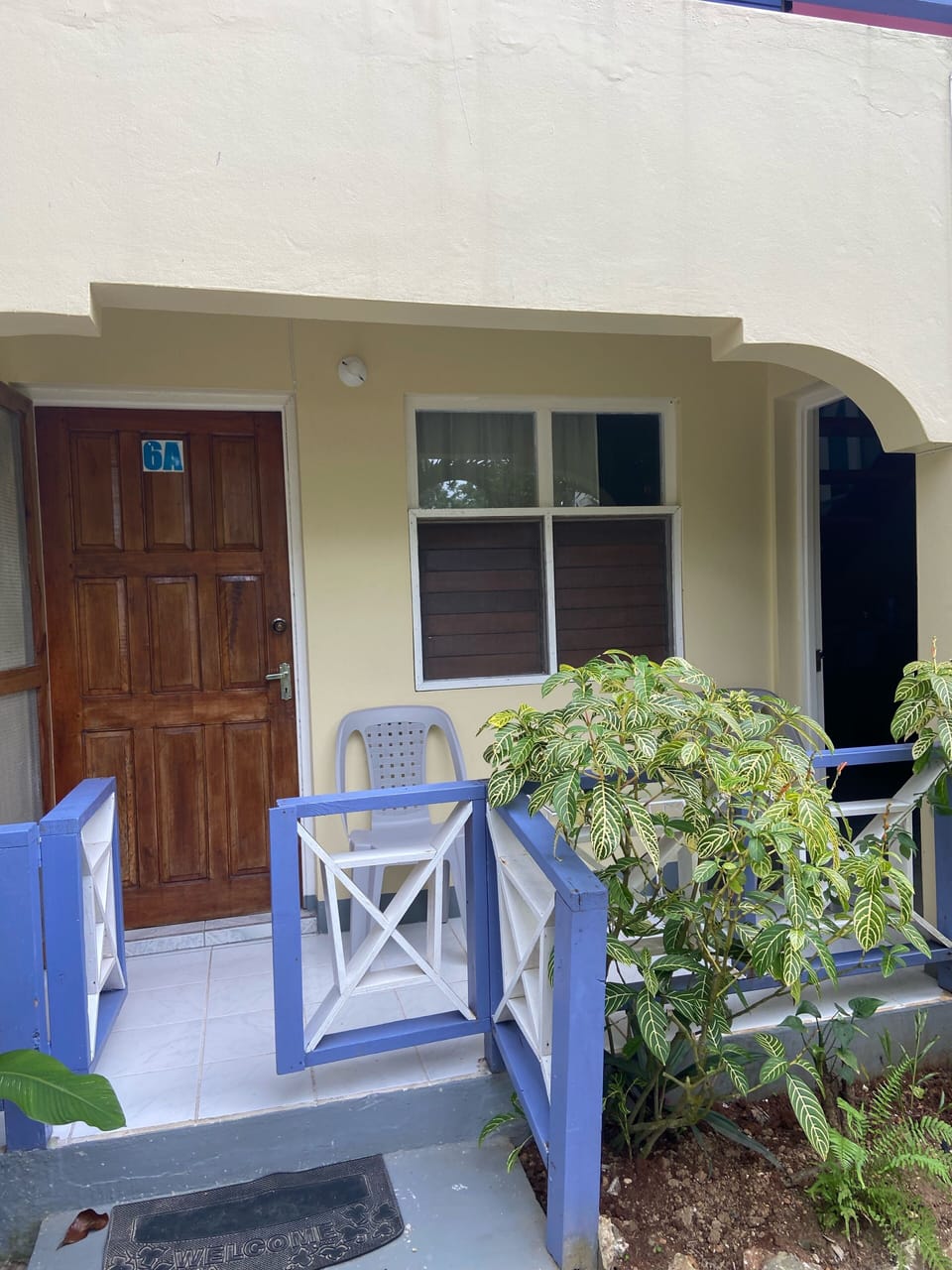 Outdoor Colorful Patio with Seating and Secure Locked Door Entrance
