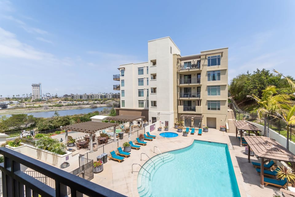 Balcony view with pool, San Luis Rey River, mountains, and Harbor