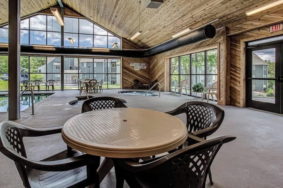 Indoor Pool Oasis: Dive into relaxation with modern decor and stunning views of the outdoors!