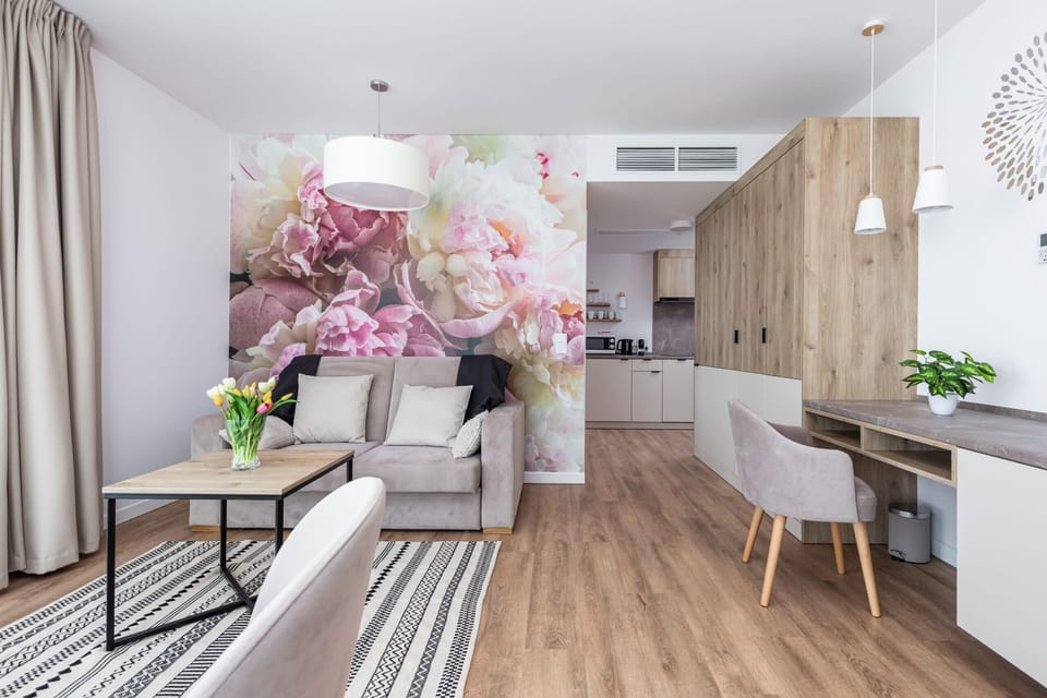 The elegant living room featuring a double sofa bed and a desk.