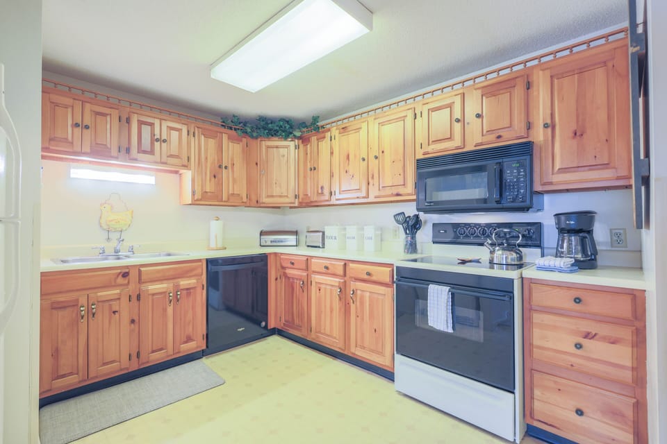 Kitchen has full size appliances, glass ware, flatware dishware, cooking utensils and pots & pans.