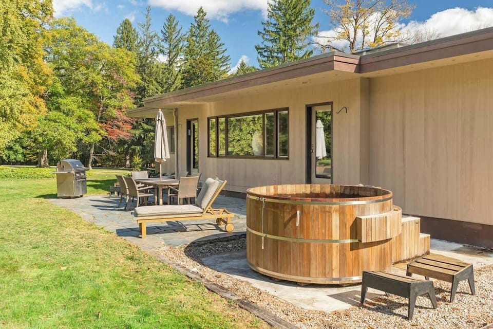 Patio with hut tub from Maine Cedar Hot Tubs, seven foot diameter. Lynx grill. Chaise. Teak table for six. 