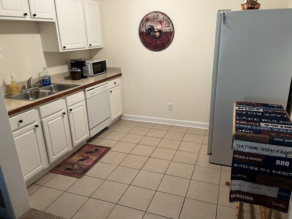 Lower level kitchenette with appliances including Keurig