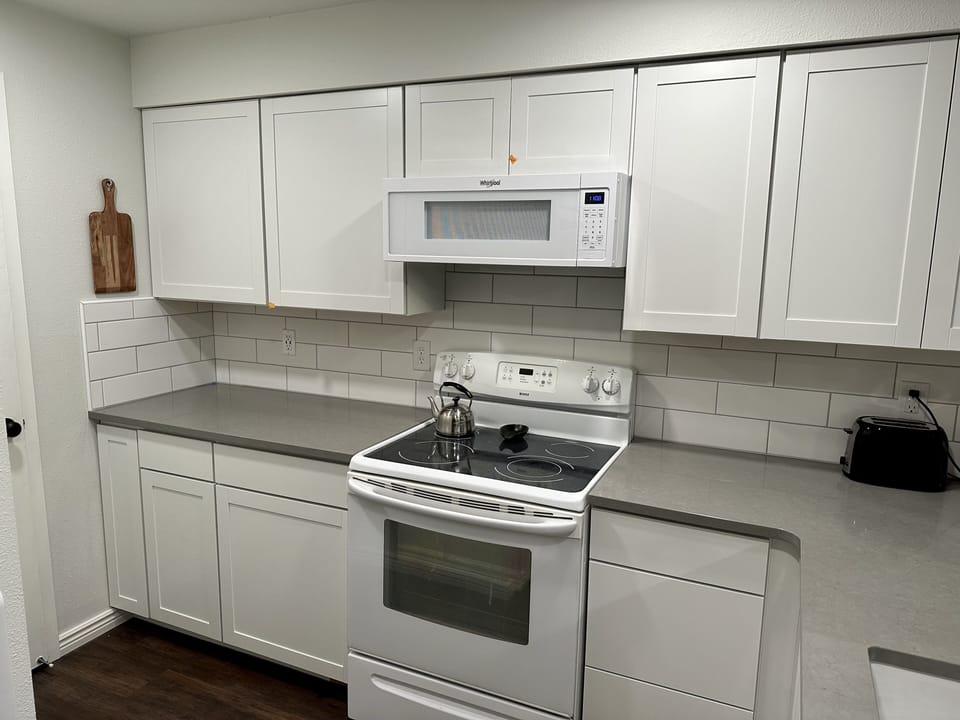 Beautiful new kitchen fully stocked with cookware, spices and some pantry basics