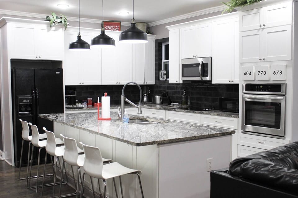 Large Kitchen for cooking with family or friends, stainless steel appliances.  Dinning room is off to your left and bedrooms are right behind the chai