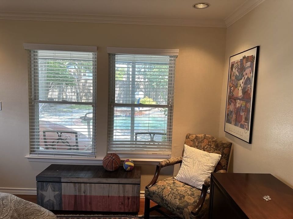 sitting area and dresser in the bedroom view on the pool