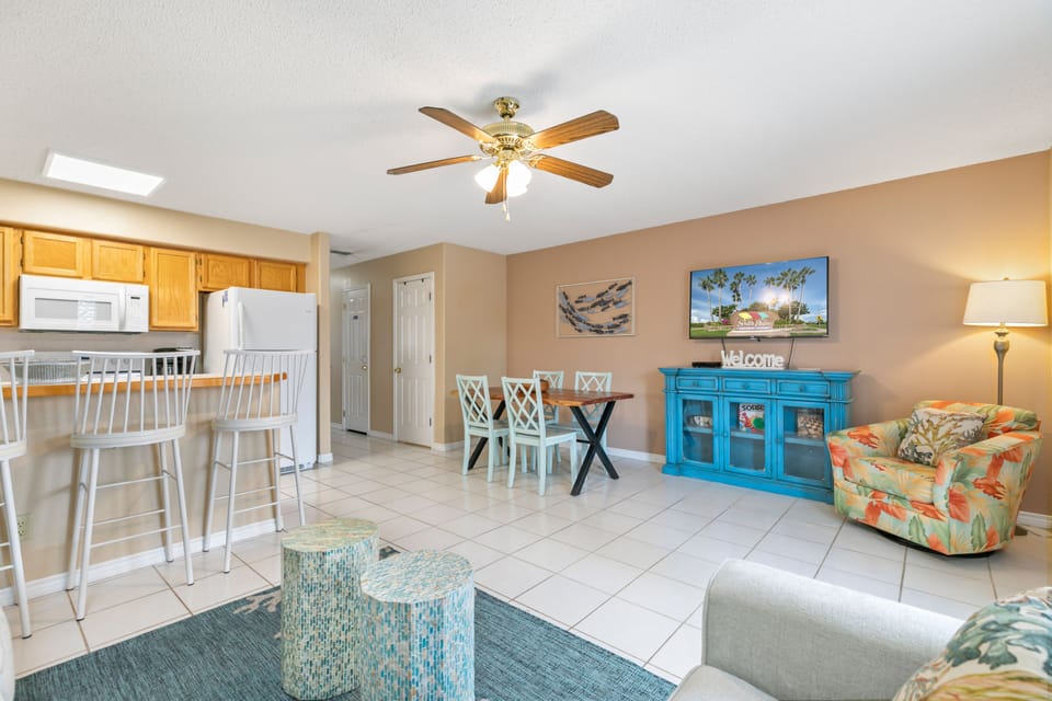 Open Concept Living Room with seating surrounding a Flat screen TV