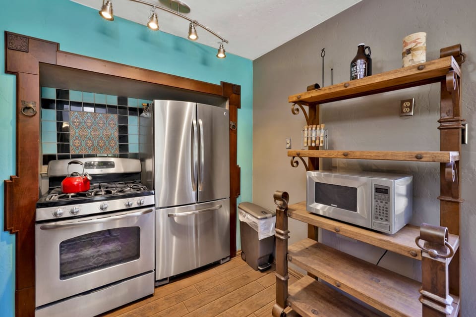 Fully equipped cabin kitchen with ample cabinetry, stove, fridge, microwave, and coffee maker—perfect for cooking meals, morning coffee, and feeling right at home on your stay.