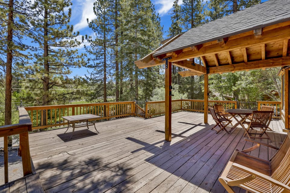 Private outdoor deck surrounded by tall pines, perfect for relaxing under the trees after a day of adventure—enjoy peaceful forest views, fresh air, and a truly rejuvenating stay.