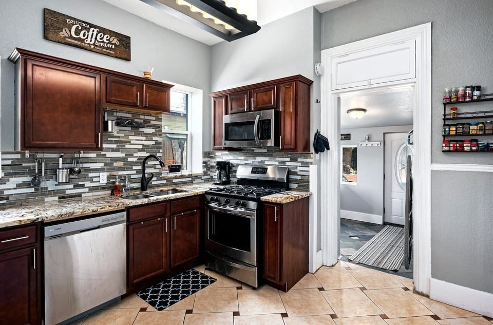 - Cook like a pro with a gas range, built in microwave, and ample prep space
- Open layout connects to laundry area for ultimate guest convenience
- Stylish tile floors and modern lighting add to the inviting atmosphere