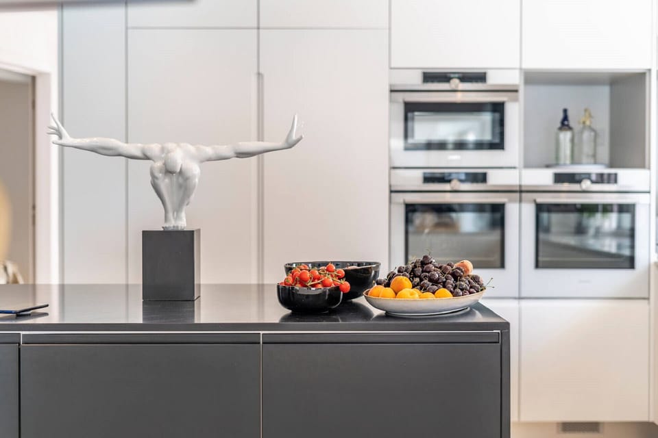 Modern kitchen island with white sculptural art — Villa Alba, luxury holiday villa in Marisol