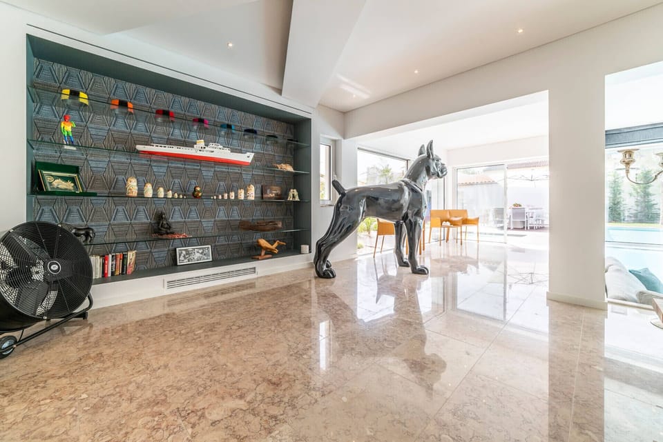 Modern gallery space with dark shelving and black horse sculpture — Villa Alba, luxury holiday villa in Marisol