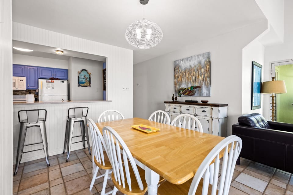 Gather around your spacious dining table where shared meals become cherished memories under elegant pendant lighting.