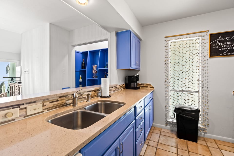 Your modern kitchen features bright blue cabinets, granite countertops, and all the essentials for preparing memorable meals during your stay.