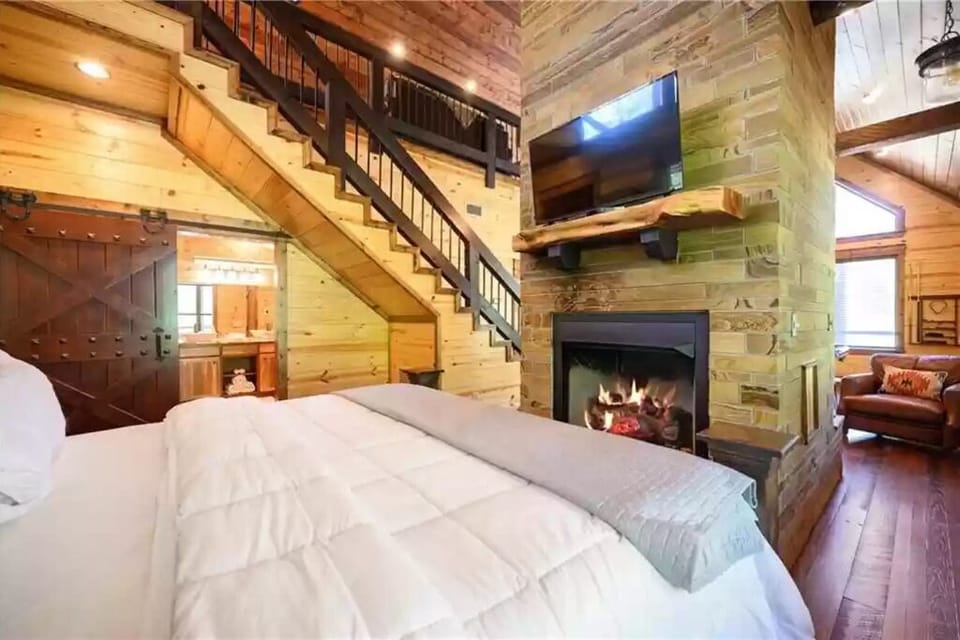 King bed and fireplace from other side.  TV here too.