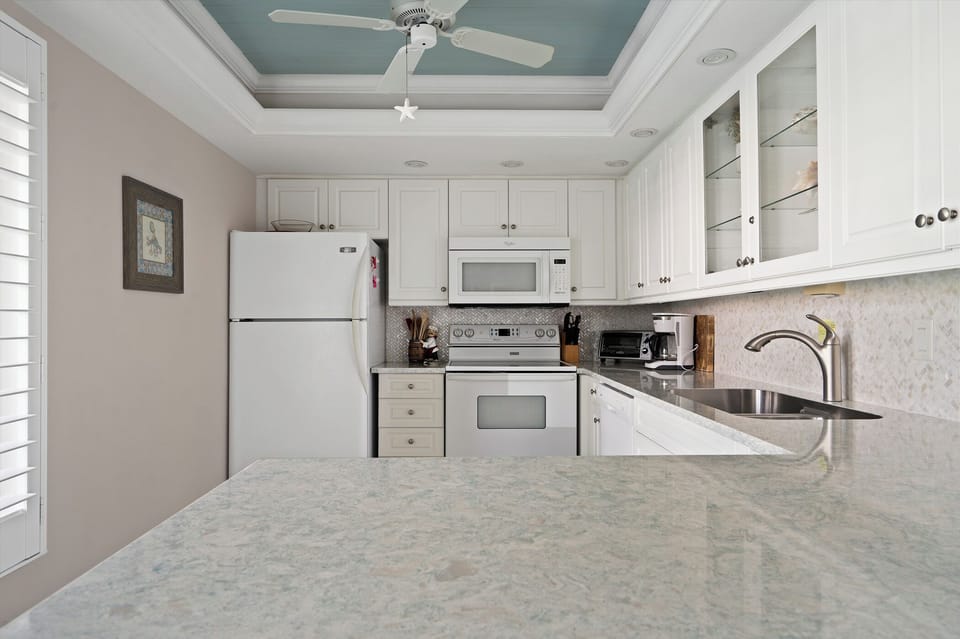 Gorgeous solid surface counters and tile backsplash.