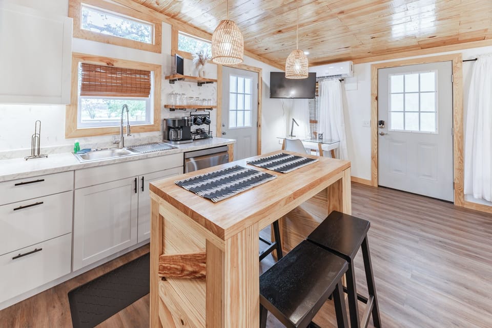 Our open kitchen features a welcoming bar, perfect for morning coffee.