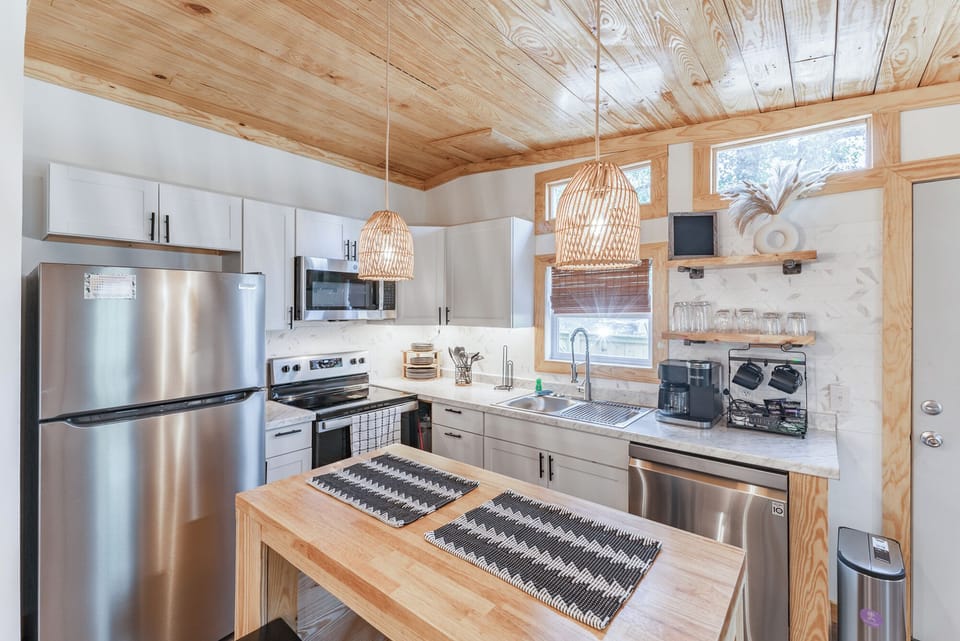 brand-new modern kitchen boasts gleaming stainless-steel appliances.
