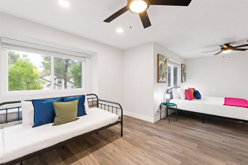 Relax in this bright, comfy bedroom with modern decor and plenty of natural light.