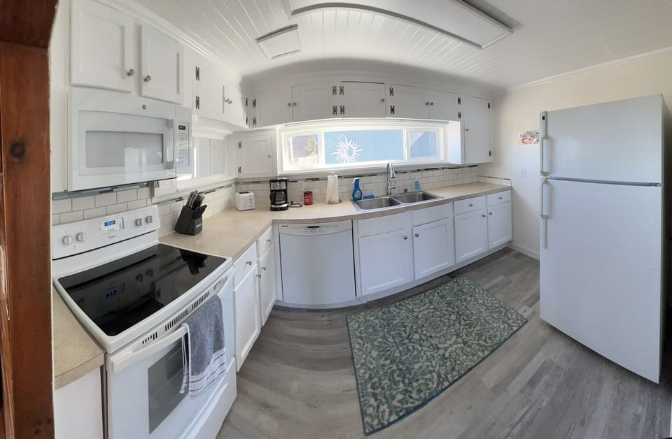 Panoramic kitchen view-well appointed, with full size fridge.